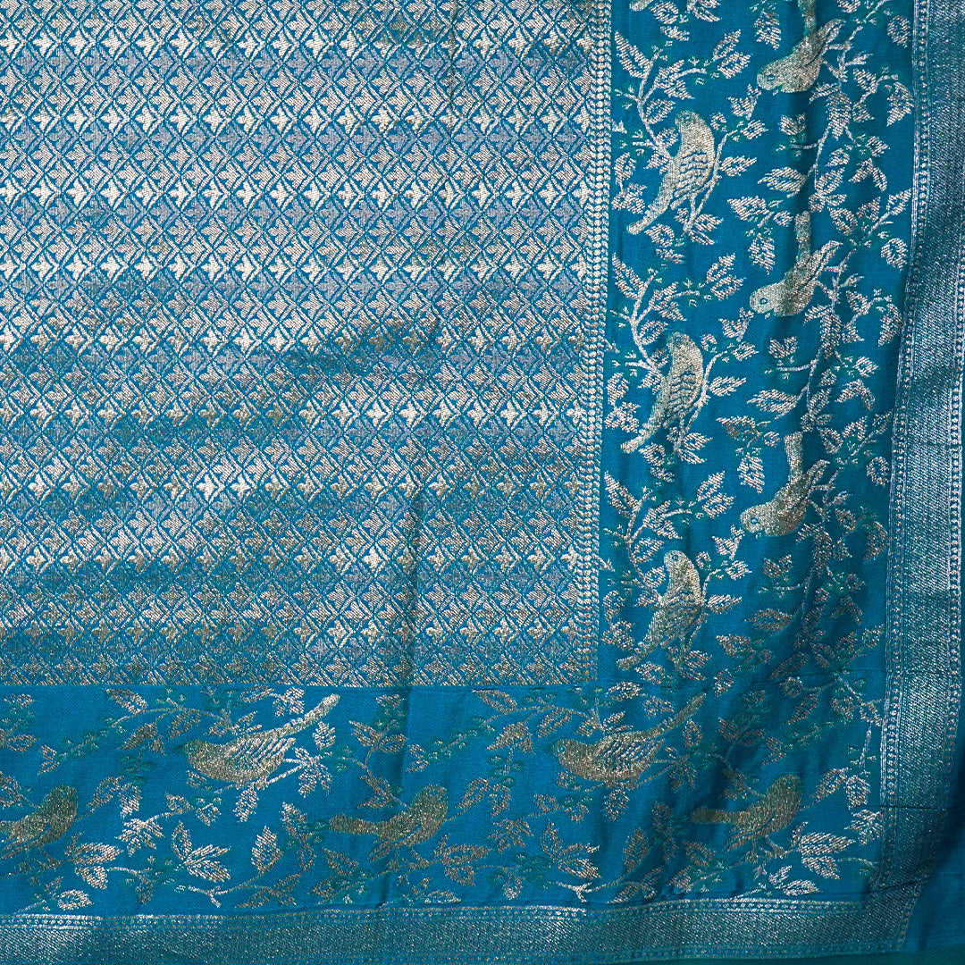 Hamsini Silk saree in Vibrant teal blue shade with a lustrous silk texture.