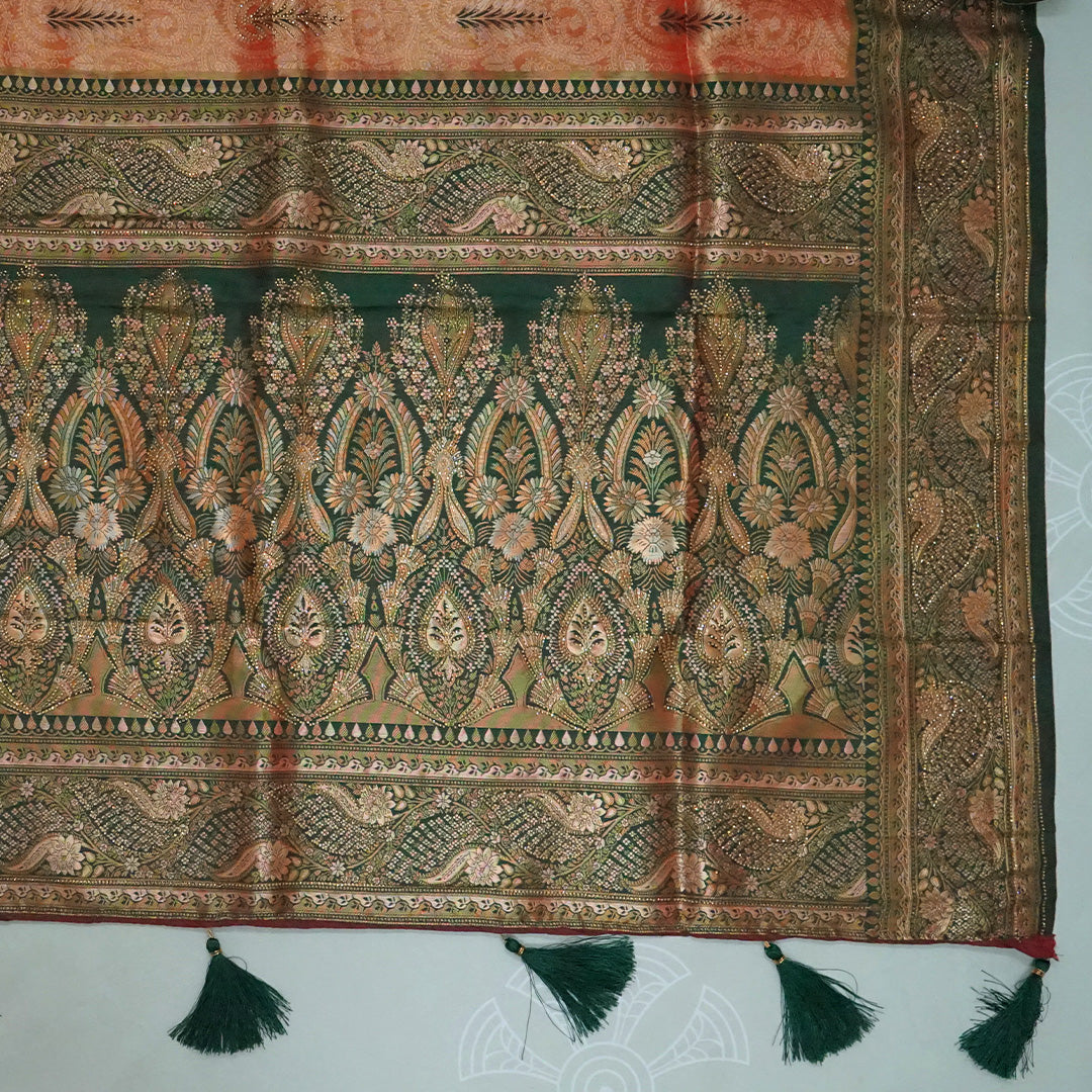 Madhur Bela rich coral-orange shade with a golden undertone.