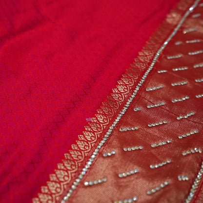 Samrudhi Silk saree in vibrant crimson red with a shimmering copper-toned border.