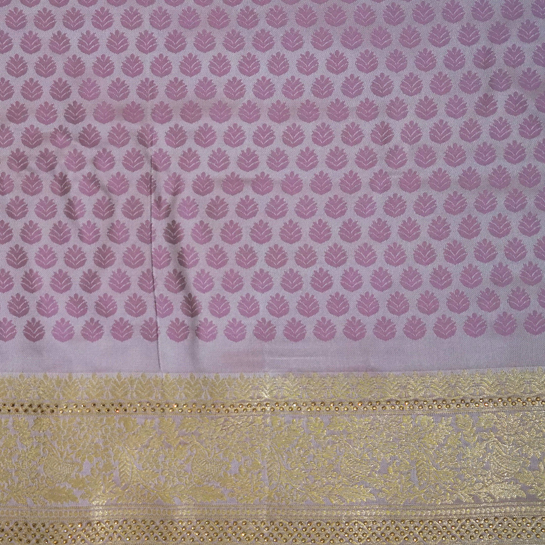 Vedika Silk saree in soft pastel pink shade with a luxurious golden zari weave.