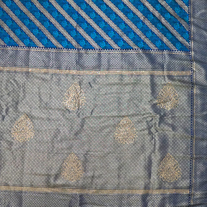 Megha Silk saree in rich royal blue with alternating metallic gold zari stripes.