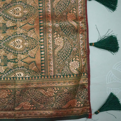 Madhur Bela rich coral-orange shade with a golden undertone.