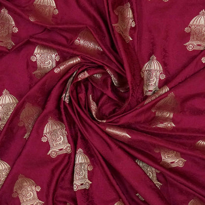 Royal Ratha Banarasi silk in deep maroon red shade, highlighted with rich golden zari motifs and an ornate golden border.