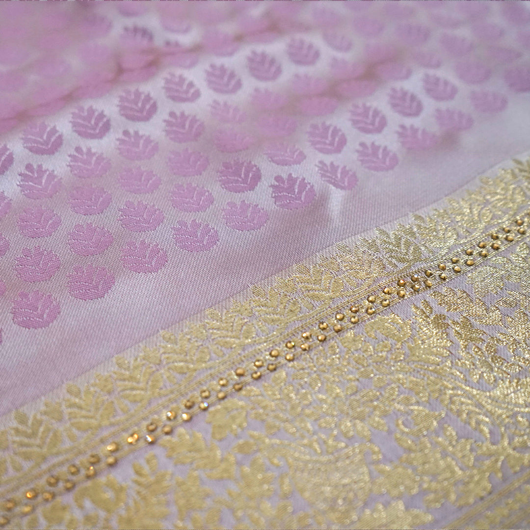 Vedika Silk saree in soft pastel pink shade with a luxurious golden zari weave.