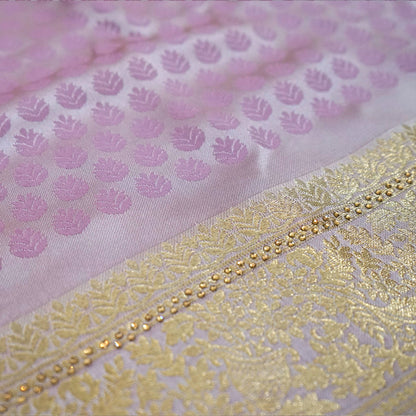 Vedika Silk saree in soft pastel pink shade with a luxurious golden zari weave.