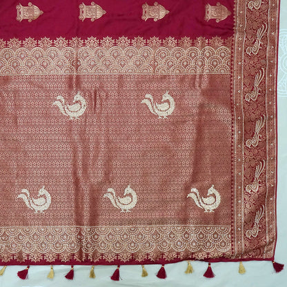 Royal Ratha Banarasi silk in deep maroon red shade, highlighted with rich golden zari motifs and an ornate golden border.