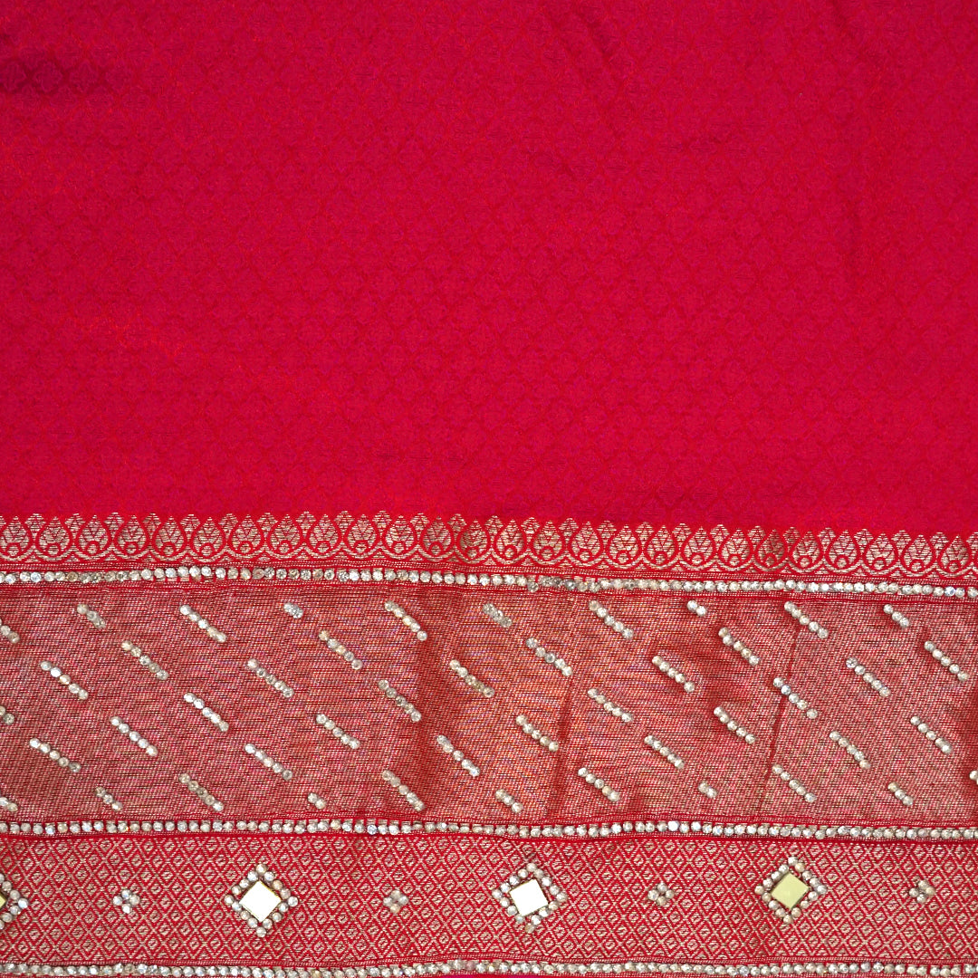 Samrudhi Silk saree in vibrant crimson red with a shimmering copper-toned border.