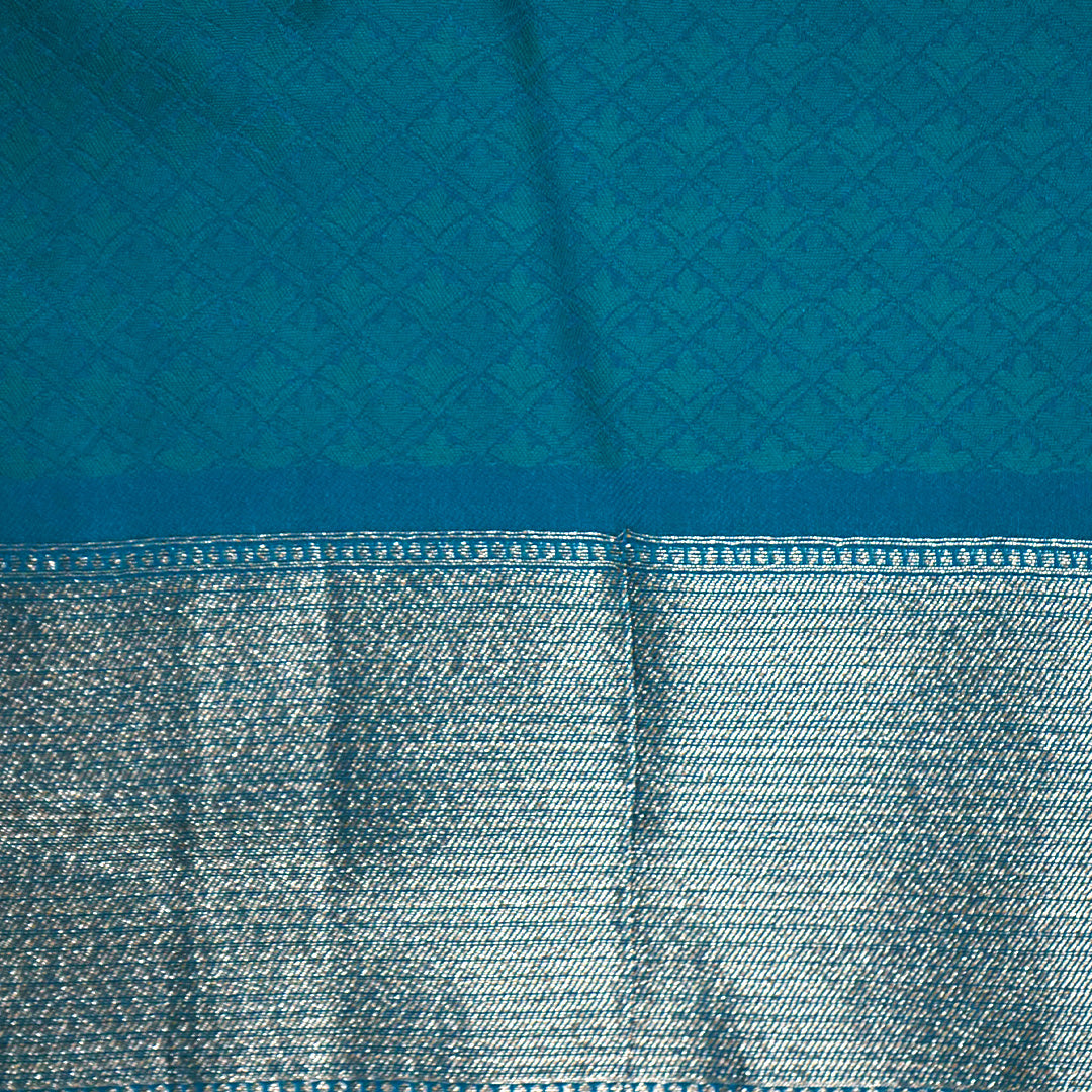 Hamsini Silk saree in Vibrant teal blue shade with a lustrous silk texture.