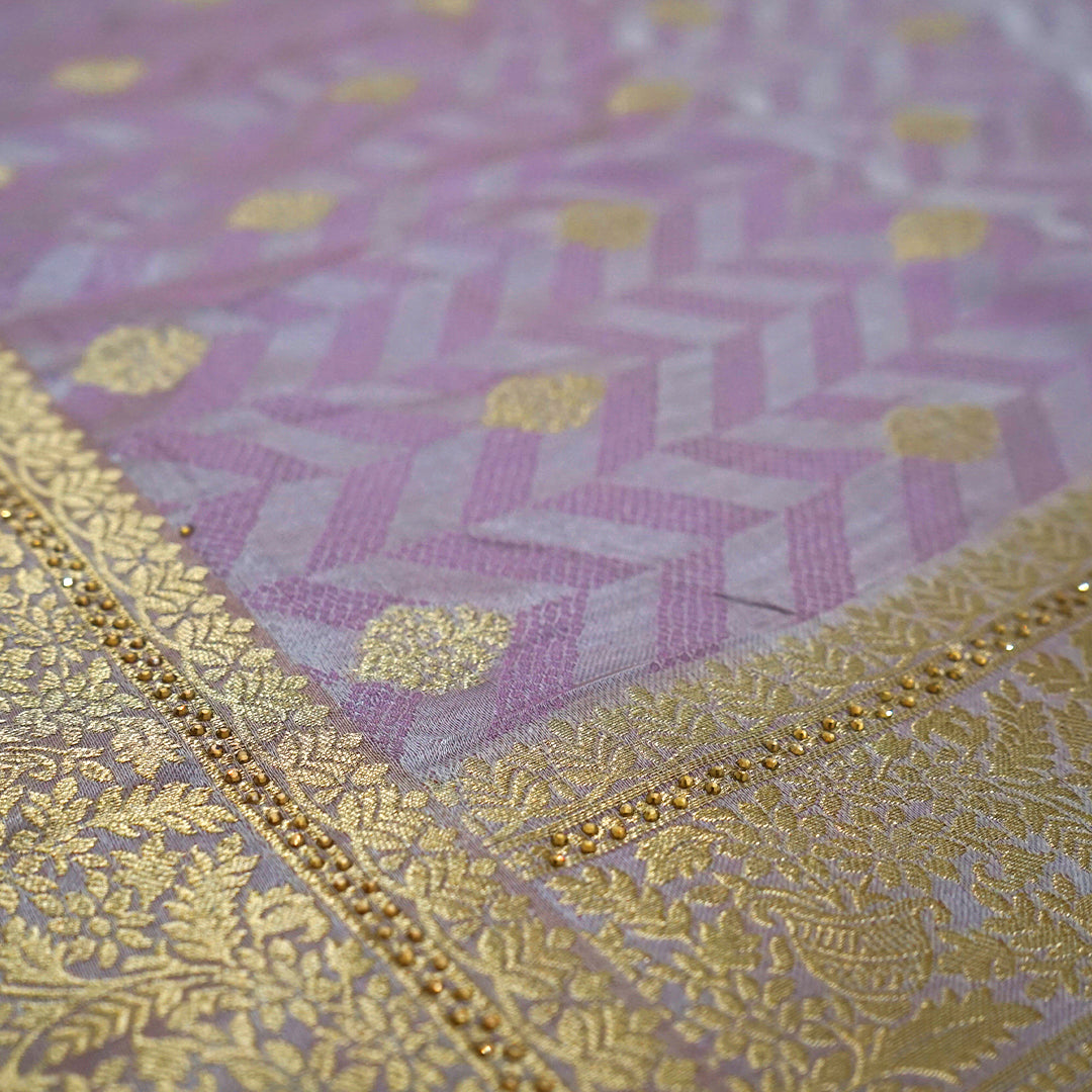 Vedika Silk saree in soft pastel pink shade with a luxurious golden zari weave.