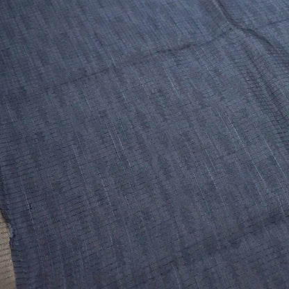 Harini Tussar in soft off-white base with multicolored leaf motifs in shades of pink, blue, and brown, beautifully complemented by an elegant metallic grey border.