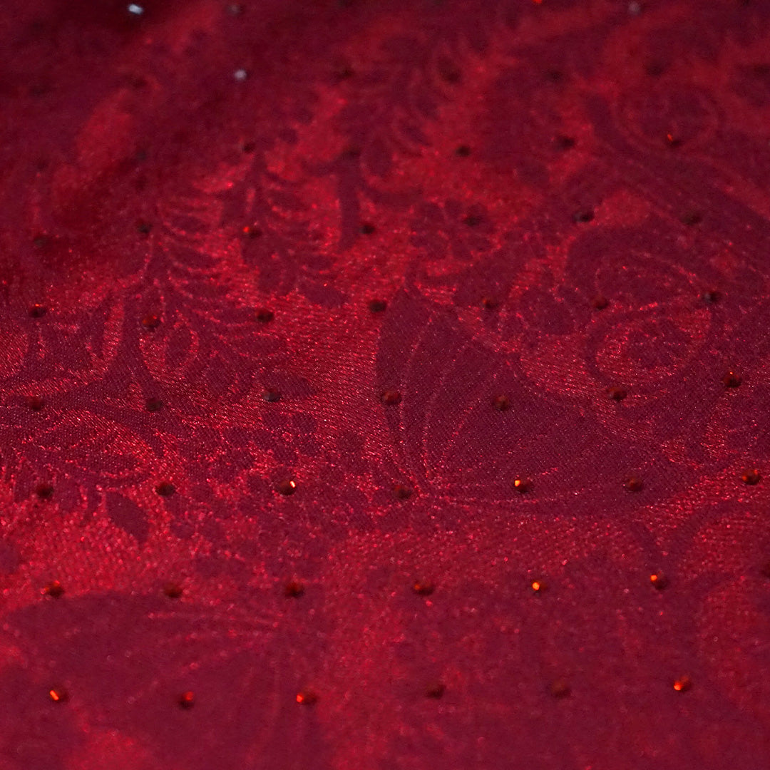 Royal Ratha Banarasi silk in deep maroon red shade, highlighted with rich golden zari motifs and an ornate golden border.