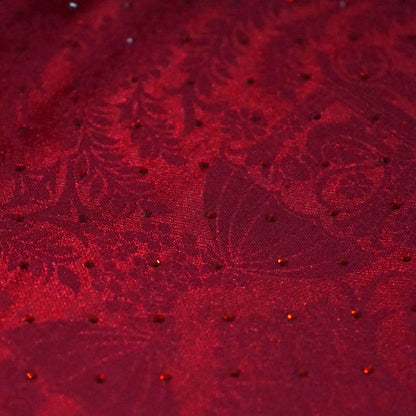 Royal Ratha Banarasi silk in deep maroon red shade, highlighted with rich golden zari motifs and an ornate golden border.