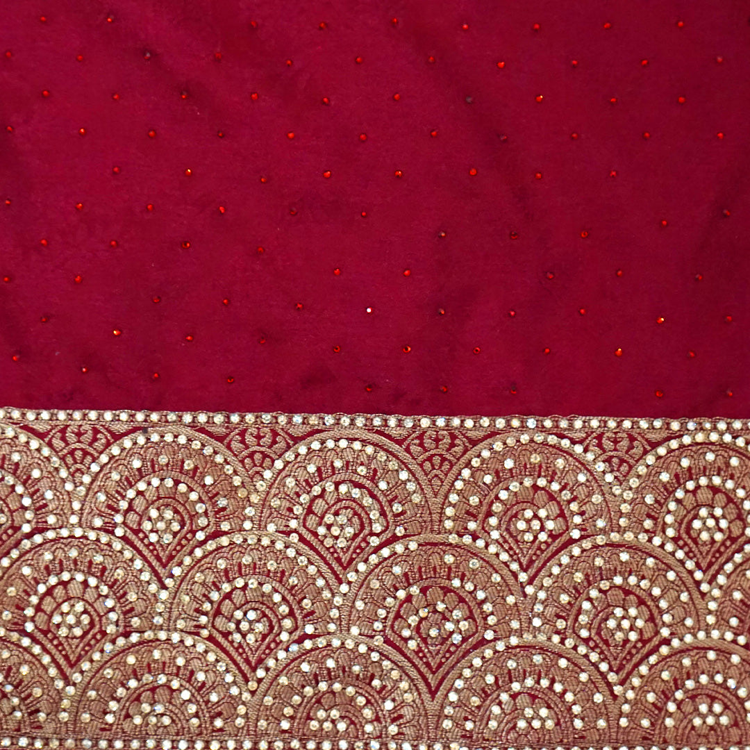 Royal Ratha Banarasi silk in deep maroon red shade, highlighted with rich golden zari motifs and an ornate golden border.