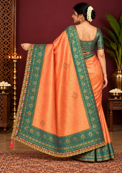 Peach-orange Raj Virasat Silk saree with Deep purple base and heavy embroidery.
