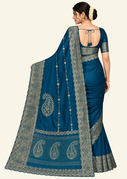 Ratnalekha silk saree in rich teal-blue base adorned with intricate gold zari work,