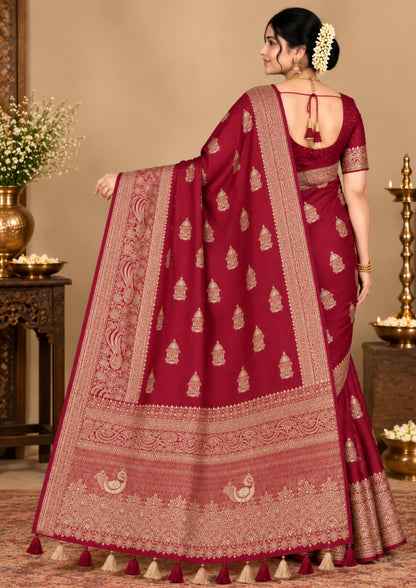 Royal Ratha Banarasi silk in deep maroon red shade, highlighted with rich golden zari motifs and an ornate golden border.