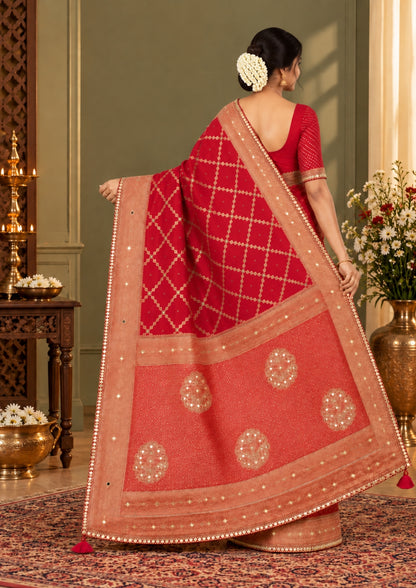 Samrudhi Silk saree in vibrant crimson red with a shimmering copper-toned border.
