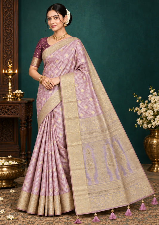 Vedika Silk saree in soft pastel pink shade with a luxurious golden zari weave.