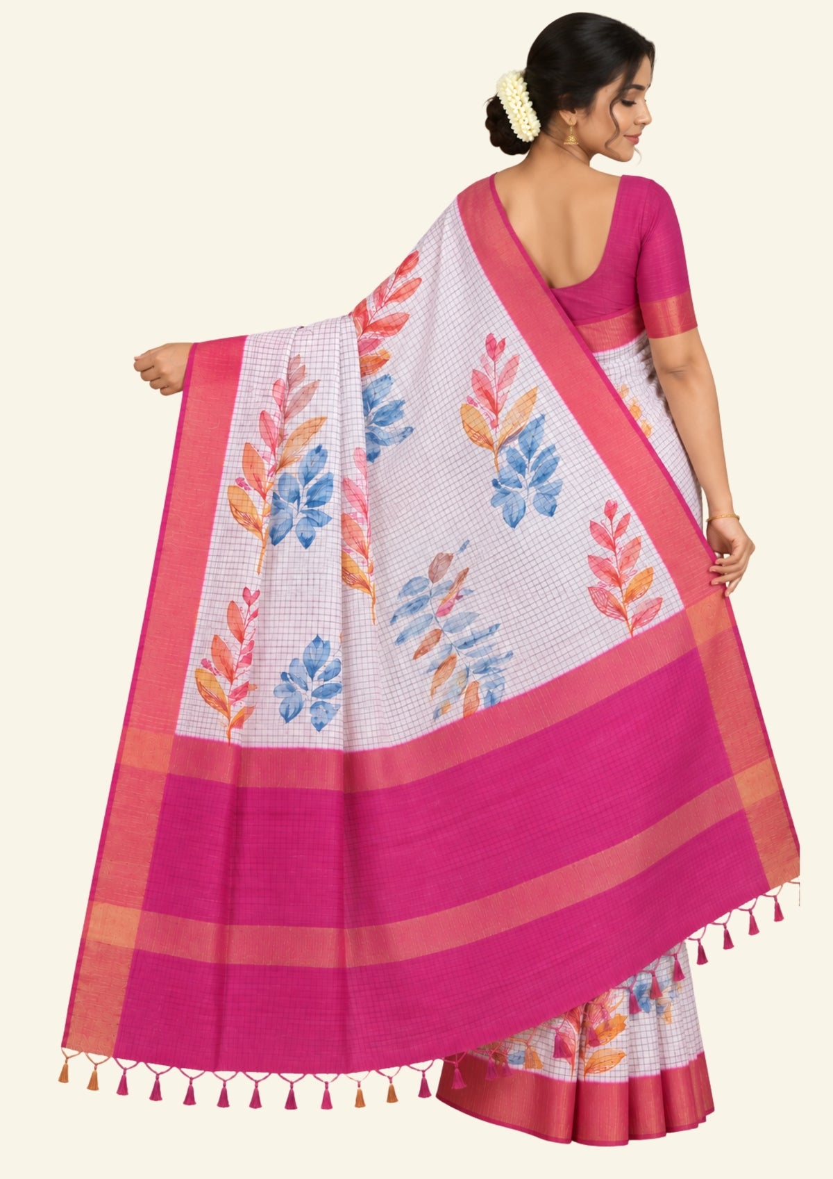 Harini Tussar in soft white base with colorful leaf motifs in blue, orange, and mustard, complemented by a rich maroon border.